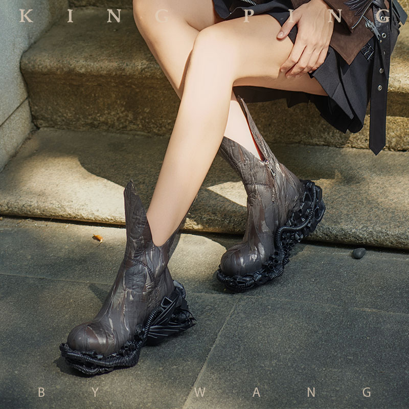 This Runway Inspired Statement Shoes by KING PING features an elongated shaft and an aggressively engineered sole that emphasizes strength, structure, and presence. The silhouette combines avant-garde proportions with a raw, architectural aesthetic, creating a powerful visual statement designed for confident, style-driven wearers.